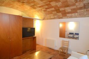 a living room with a flat screen tv and a couch at Casa Flora - Cadaqués in Cadaqués