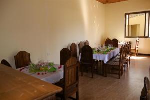 a dining room with a table and chairs with white tablecloths at Tabor Hotel Lalibela in Lalībela