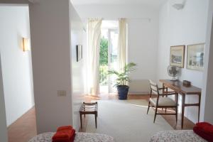 a living room with a table and a dining room at Casa Flora - Cadaqués in Cadaqués