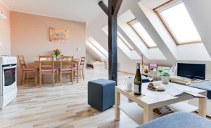 a living room and dining room with skylights at Jane's Attic Apartment in Prague