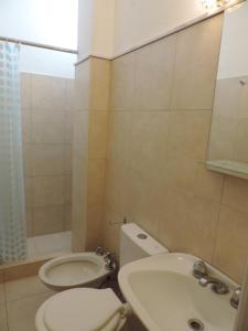 
a bathroom with a sink, toilet and bathtub at Hotel My Way in Mar del Plata
