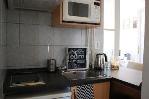 a kitchen with a sink and a microwave at Panorama apartment in Budapest