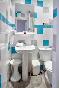 a bathroom with a sink and a toilet at Hôtel du Nord in Annecy