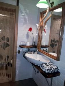 a bathroom with a sink and a mirror at La Cabaña de Catalina in Sotres +16 photos