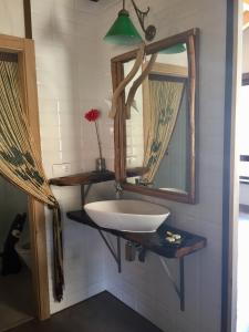 a bathroom with a sink and a mirror at La Cabaña de Catalina in Sotres
