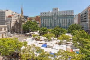 a group of white tents in a city with buildings at Market House 30C in Cape Town