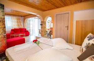 a bedroom with a bed and a living room at Villa Elpis 2 in Limenaria