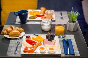 a table with two plates of breakfast food on it at D8 Hotel in Budapest