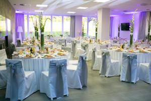 a set of tables with white chairs and plates of food at Penzión Aqua Maria in Veľaty +71 photos