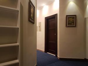 a hallway with a door leading to a room with a television at Paradise Boutique Hotel in Cairo