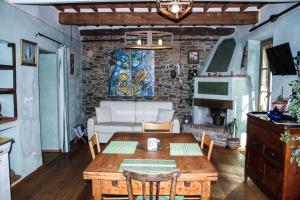 a living room with a wooden table and a brick wall at Residenza Fra Le Torri - Charme & Art Gallery Home in Arezzo