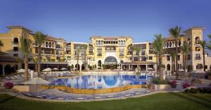 a large building with a large pool in front of it at Luxe appartement on Mar Menor Golf Resort with Padel, Fitness, Wellness facilities in Torre-Pacheco