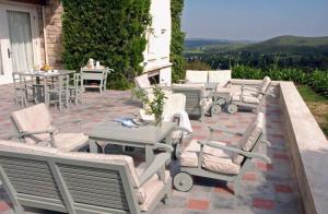 a group of chairs and tables on a patio at El Castillo de Mandl in La Cumbre +34 photos