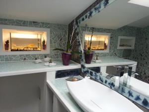 a bathroom with a sink and two mirrors at Apartma Marisol in Izola +57 photos