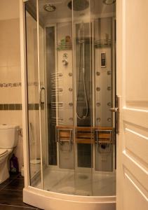 a shower with a glass door in a bathroom at Madeleine in Boncourt
