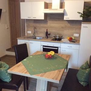 a kitchen with a table with a bowl of fruit on it at Weitlaner Birgit in Sillian