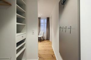 a walk in closet with a desk and a chair at Maximilian Apartments Lindau in Lindau