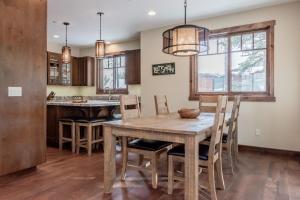 a kitchen with a wooden table and chairs at Gray Bear 454 in Mammoth Lakes