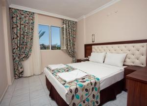 Кровать или кровати в номере Ozturk Apart Hotel