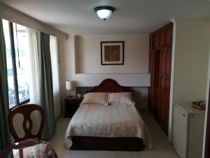 Postel nebo postele na pokoji v ubytování HOTEL COSTA DEL SOL FUSAGASUGa