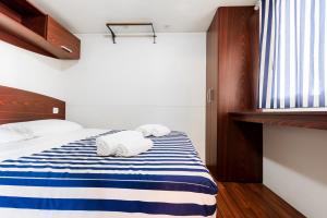 Ein Bett oder Betten in einem Zimmer der Unterkunft Real Village Roma