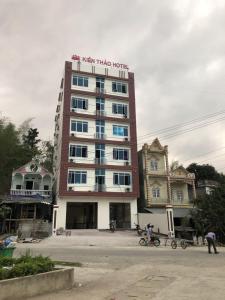 a tall building with people standing in front of it at Kien Thao Hotel in Ha Giang