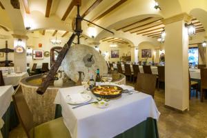 a dining room with a table with a plate of food at Hotel Tossal d'Altea in Altea