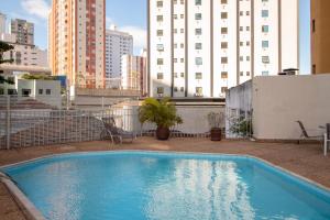 a swimming pool on the roof of a building at Royal Center Hotel Lourdes in Belo Horizonte