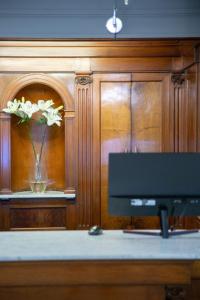 a table with a vase of flowers in a room at Carsson Hotel Downtown Buenos Aires in Buenos Aires