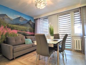 a living room with a couch and a table at VIP Apartamenty Kasprusiowy Zakatek in Zakopane