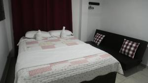 1 dormitorio con 1 cama con edredón en Inn Bless Aparthotel, en San Andrés