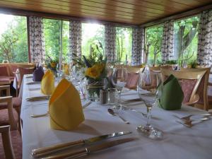 a table with wine glasses and flowers on it at Hotel-Café "Schauinsland" in Horn-Bad Meinberg