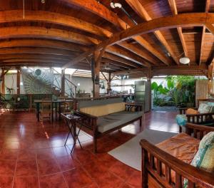 a large living room with wooden ceilings and furniture at Sueño Grande B&B in Puerto Viejo