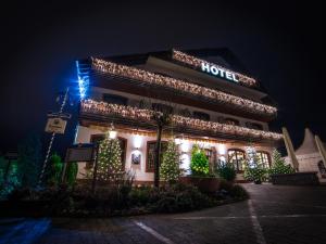 a hotel is decorated with christmas lights at night at Hotel zur Moselbrücke in Schweich