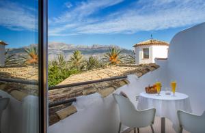 a view from the balcony of a house with a table and chairs at Hotel Tossal d'Altea in Altea