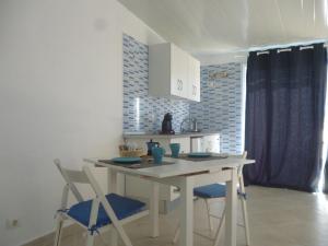 a kitchen with a table and chairs in a room at Roca Mar Tenerife in La Mareta