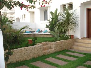 a garden with a bench in the side of a building at Villa El Andalousse in Larache
