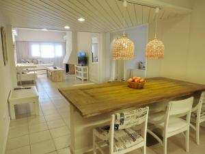 a kitchen with a table with a bowl of fruit on it at Atlántico Boutique Hotel in Punta del Este