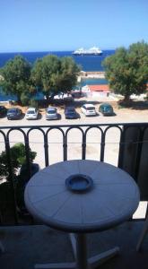 a table on a balcony with a view of a parking lot at Rooms 47 in Chania Town