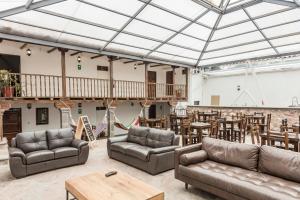 a large living room with couches and tables and a dining area at Hotel Casa Fierro Cusco in Cusco