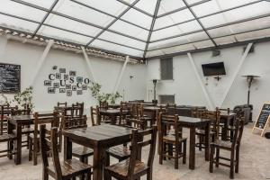 a dining room with wooden tables and chairs at Hotel Casa Fierro Cusco in Cusco