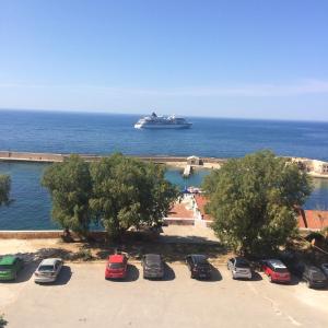 a cruise ship in the ocean with cars parked at Rooms 47 in Chania Town