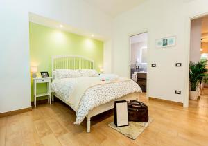 a bedroom with a bed and a mirror on the floor at B&B Vico Milano 18 in Naples