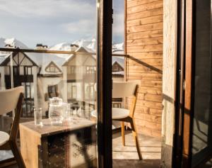 a view from a balcony with a table and chairs at New Gudauri Loft #1,Room 411, 412 in Gudauri