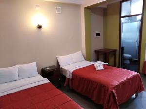 Postel nebo postele na pokoji v ubytování Hotel Plaza Bolognesi 344