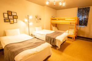 a bedroom with two beds and a bunk bed at SLOW HOUSE NARA in Nara