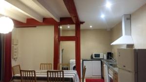 a kitchen with a table and chairs in a room at T3 rénové Luz Centre in Luz-Saint-Sauveur