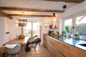 a kitchen with a wooden counter top and a table at exklusives Alpenchalet mit Jacuzzi & Sauna für bis zu 14 Personen in Bayrischzell +15 photos