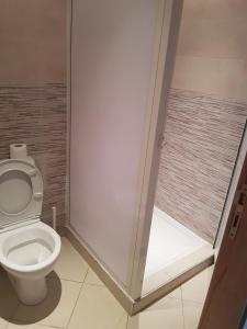 a bathroom with a toilet and a walk in shower at Prestige appartement coeur du Rabat in Rabat