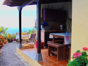 a kitchen with a table and a view of the ocean at Casa Rosa in Tijarafe